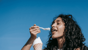 After a stressful day, woman is emotionally eating some ice cream.