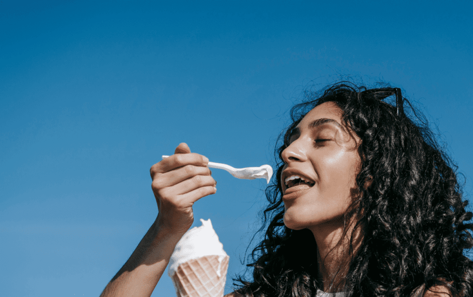 After a stressful day, woman is emotionally eating some ice cream.