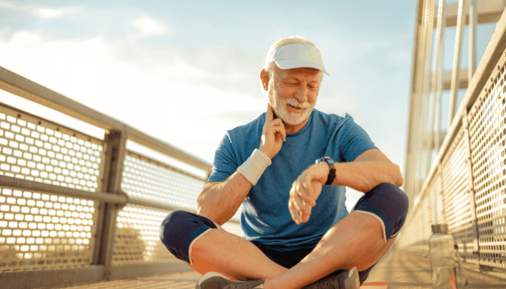 Male over 60 checking heart rate to make sure he is in the fat burning mode.