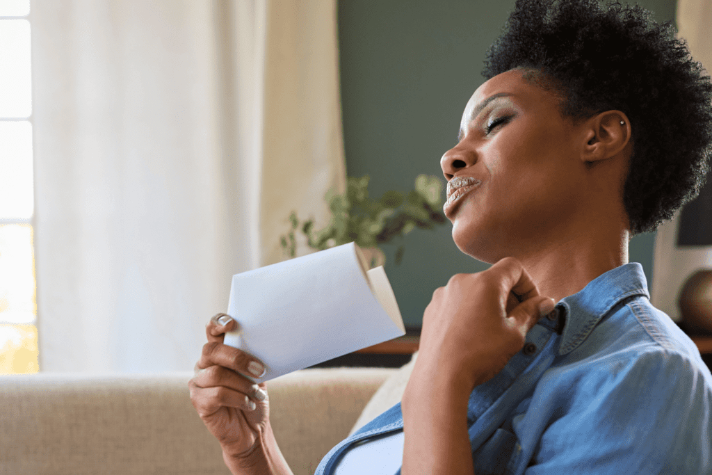 woman fanning herself after a hot flash and worried about weight gain